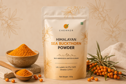 Cherker sea buckthorn berry powder beside a spoon, yoghurt, smoothie and fresh orange berries