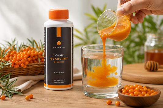 Hand pouring Cherker sea buckthorn pulp into a glass of water beside the bottle and fresh berries