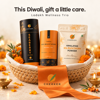 Cherker Ladakh Wellness Diwali trio gift basket with black Seaberry Purée tin, tea canister and Himalayan sea buckthorn powder pouch, orange ribbon and diyas