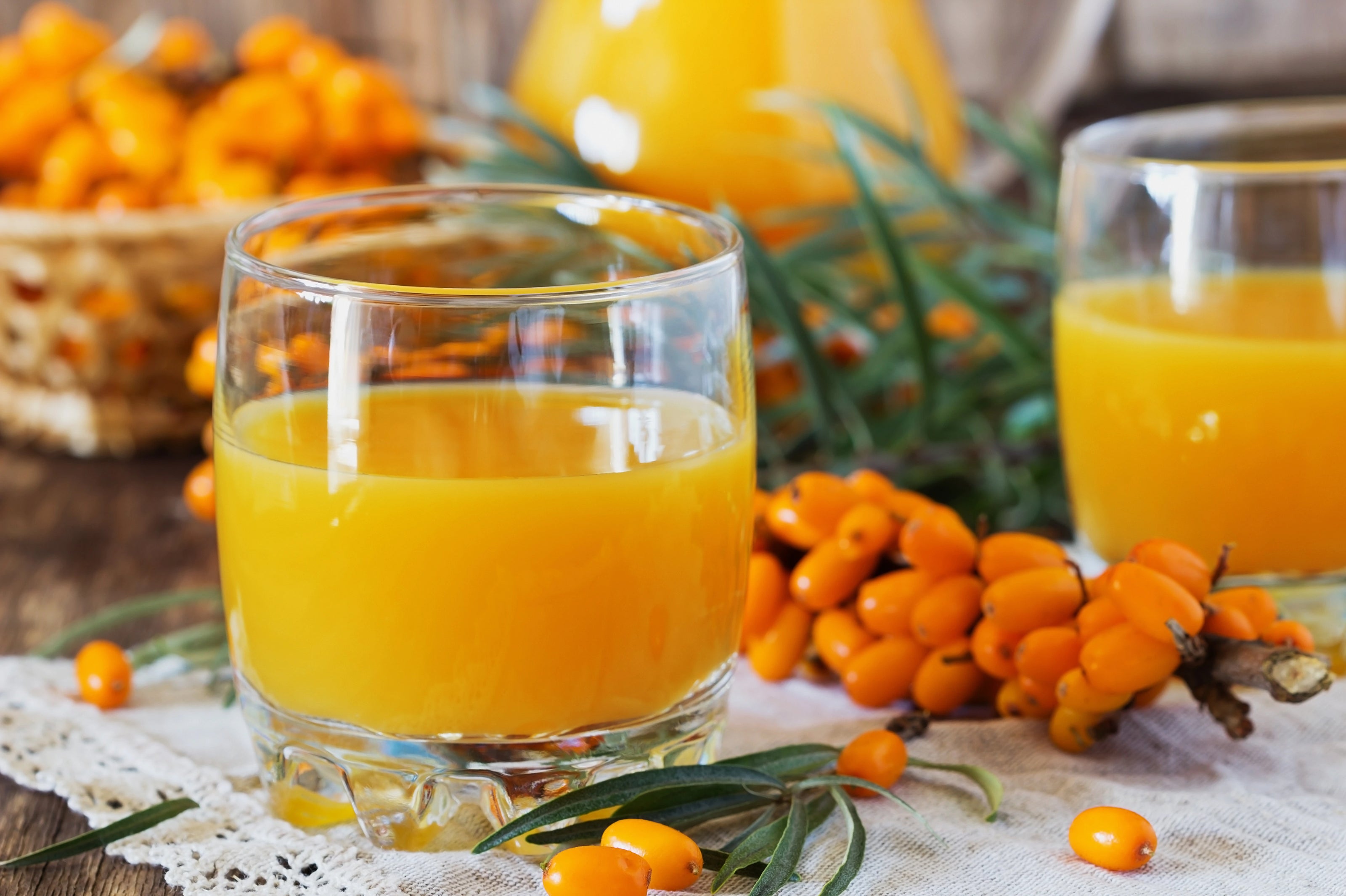 Himalayan sea buckthorn juice in glass with berries — rich in vitamin C, Omega-7, and antioxidants.